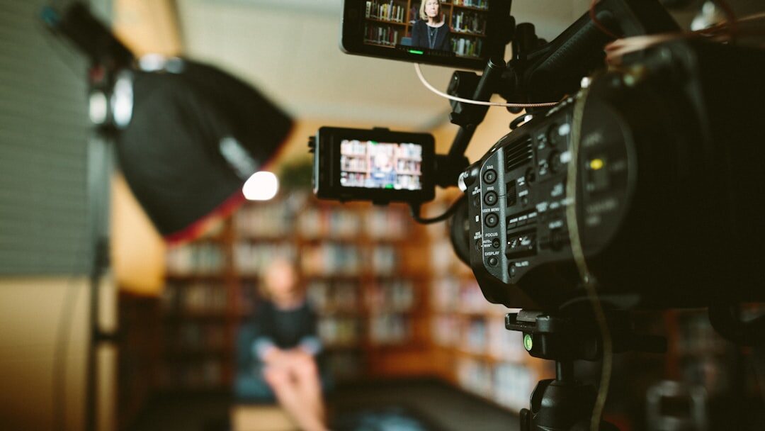 Camera operator filming with a professional video camera